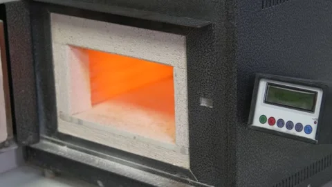 Firing of ceramic implant crowns in a special furnace at high temperature. Stock Footage 256580616