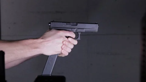 Firing A Glock Machine Gun Pistol at a Gun at a Gun Range Stock Footage 124267115