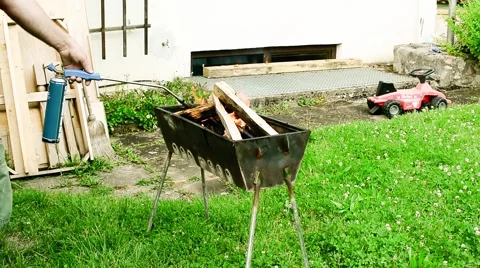 Firing a grill with a gas torch Stock Footage 65342165