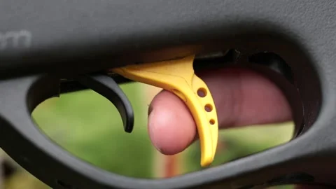 Firing a gun, very close view of a finger pulling the trigger after 스톡 동영상 194789245
