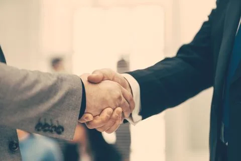 Firm business handshake on a blurry office background. Stock Photos