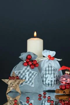 First Advent gift sacks 1,24,bark star,red decor balls and candle,copy space Stock Photos
