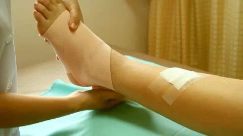 First aid bandaging ankle joint Stock Footage 26383159