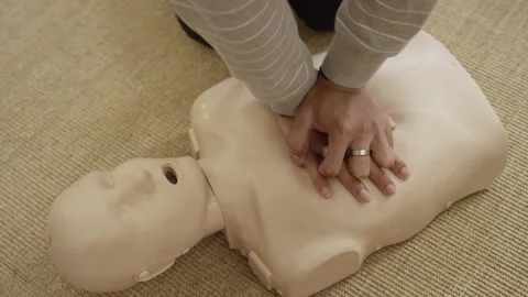 First aid certification training class practicing chest compression on dummy Video stock 168654006