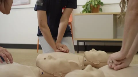 First aid certification training class practicing chest compression on dummy Video stock 168654020