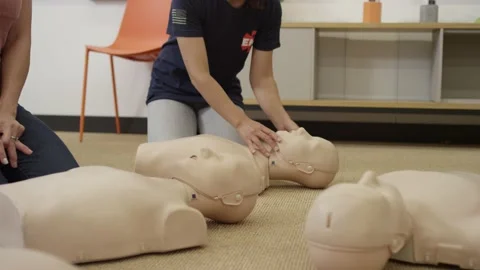 First aid certification training class practicing chest compression on dummy Video stock 168654132
