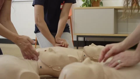 First aid certification training class practicing chest compression on dummy Stock Footage 168654271