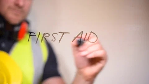 First Aid hand written on a clear screen by safety officer Stock Footage 80113425