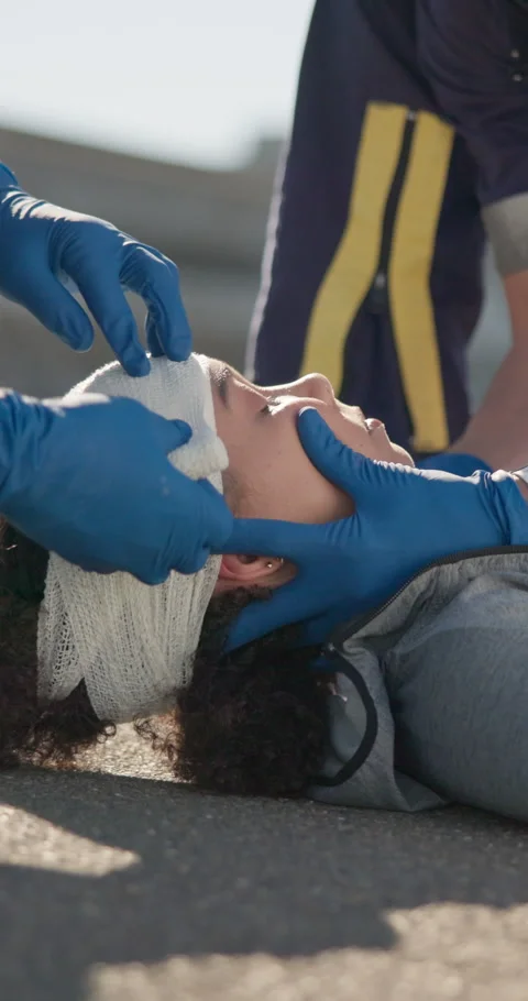 First aid, hands of paramedic and bandage on woman in accident, head injury and 스톡 동영상 252641728