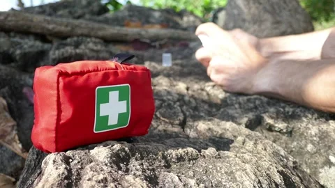 First aid on a hike in nature, a first aid kit Stock Footage 293189563