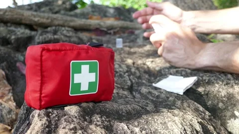 First aid on a hike in nature, a first aid kit Stock Footage 293189569