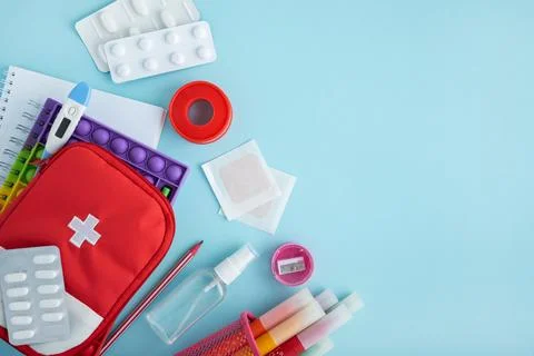 First aid kit and school supplies for student health preparedness Stock Photos