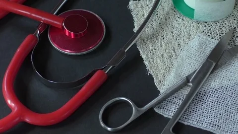 First aid kit with dressing material and red medical stethoscope Stock Footage 77536420