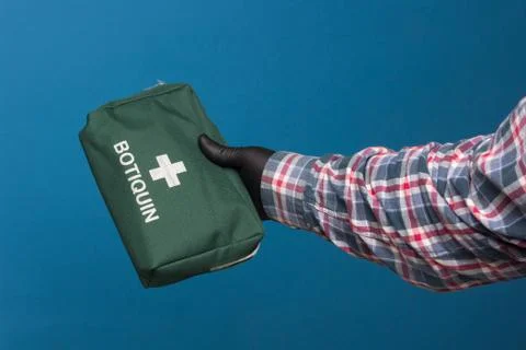 First aid kit in hand. Stock Photos