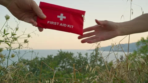 The first aid kit passes from one set of hands to another. A first aid kit is an Stock Footage 277986393