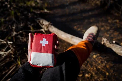 The first aid kit is red. A bag of medicines for first aid in a camping trip  Stock Photos
