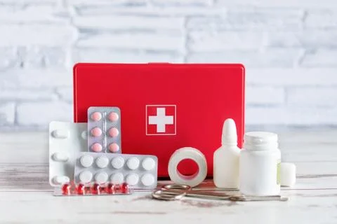 First aid kit red box with medical equipment and medications for emergency on Stock Photos