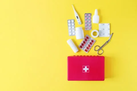 First aid kit red box with medical equipment and medications for emergency to Stock Photos