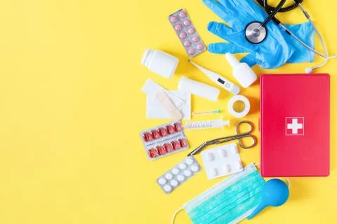 First aid kit red box with medical equipment and medications for emergency to Stock Photos