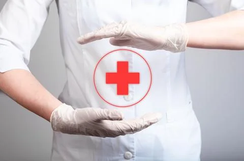 First aid. Red cross between doctor hands. Urgent medical care, immediate Stock Photos