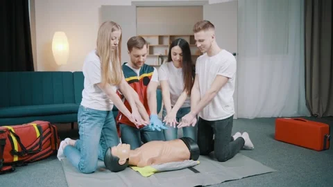 First aid resuscitation, CPR training. Students study in front of a dummy Stock Footage 234430025