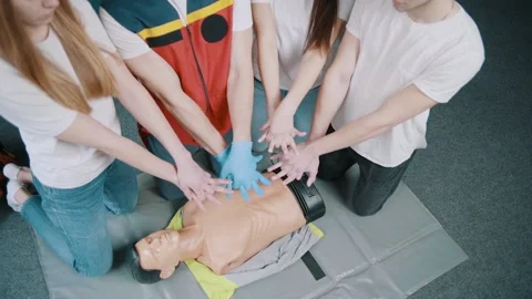 First aid resuscitation, CPR training. Students study in front of a dummy Stock Footage 234430065