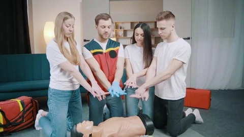 First aid resuscitation, CPR training. Students study in front of a dummy Stock Footage 255704157