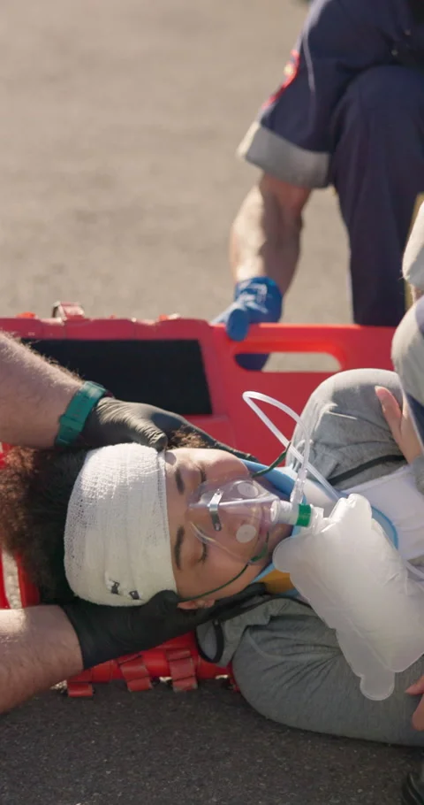 First aid, stretcher and hands of paramedics with woman in street for healthcare Stock Footage 252641777