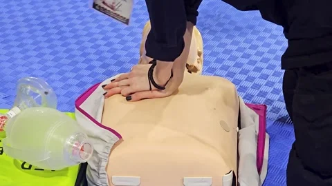 First Aid Training on Mannequin Showing CPR Chest Compression Stock Footage 337998203