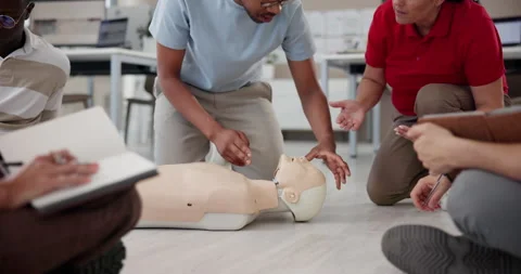 First aid training, person and instructor with mannequin for medical simulation Видео 297195613