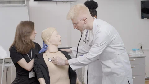 First aid training session in the clinic with a medical mannequin demonstration Stock Footage 281364701