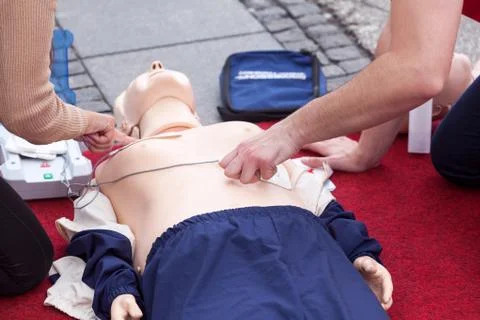 First aid training using automated external defibrillator device - AED Stock Photos
