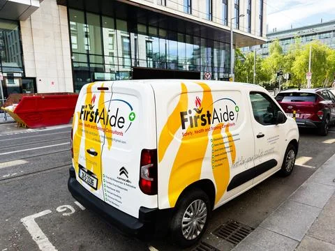 First aid van with FirstAide branding parked on a Dublin, Ireland street ou.. Фото