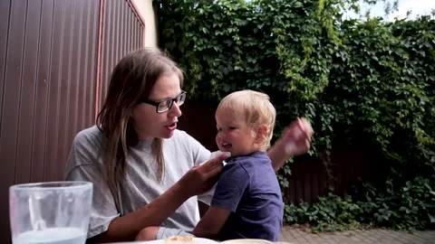First aid when lifting child off bicycle. Put cold ice abrasion prevent bruising Stock Footage 260034759