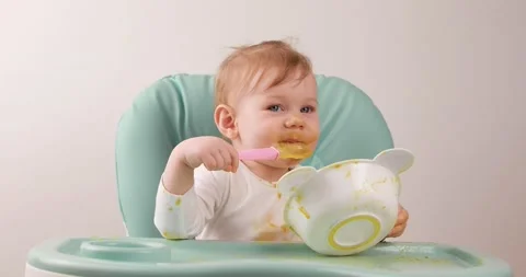 First attempt to eat on your own Stock Footage 153047763