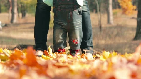First baby steps on the fall yellow leaves Stock Footage 42740548
