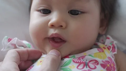 First baby tooth, deciduous tooth, primary tooth of infant kid. happy baby smile Stock Footage 165642950