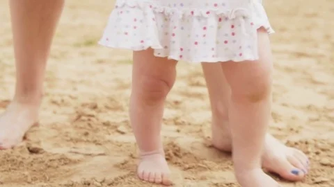 First baby's steps on the sandy beach Stock Footage 83958477
