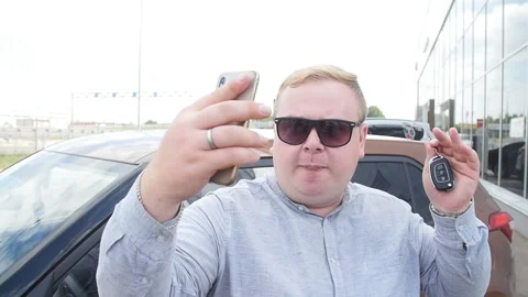 First car concept. Young man smiling making a selfie near his new car Stock Footage 94983415
