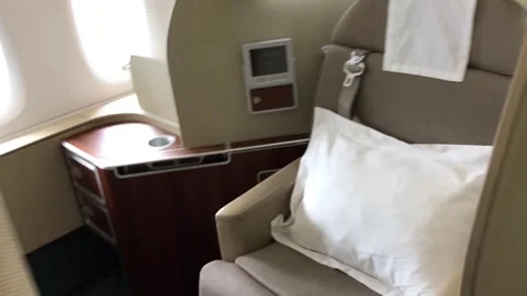 First class cabin amenities showcasing comfortable seating, pillows, and Stock Footage 317091635