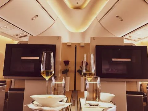 First class long flight, champagne midair. Loveley experience! Stock Photos