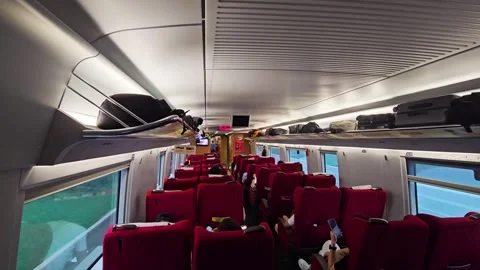 First-class passenger cabin with red seats on a Chinese bullet train, POV view Stock Footage 333524447