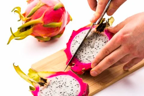 First cut through one half of a pitaya Stock Photos
