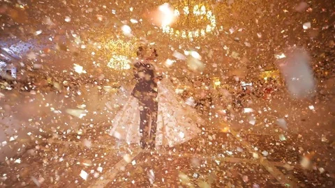 First dance of wedding pair in flying gold confetti. Stock Footage 96647185