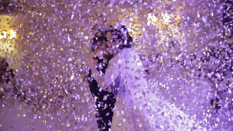 First dance of wedding pair in flying gold confetti. Stock Footage 96647273