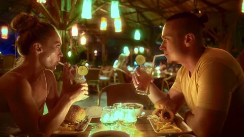 The first date couple in an open outdoor cafe, enjoying talking, laughter, fries Stock Footage 238801903