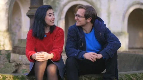 First date, park,Romance. Young lovers sitingin the park flirting,talking Stock Footage 112034321