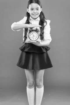 First day of fall. daily routine schedule. schoolgirl and retro alarm clock Stock Photos