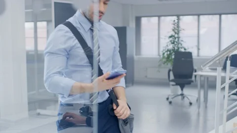First Day on New Job Businessman Walks Into Bright Modern Office, Holds Phone Stock Footage