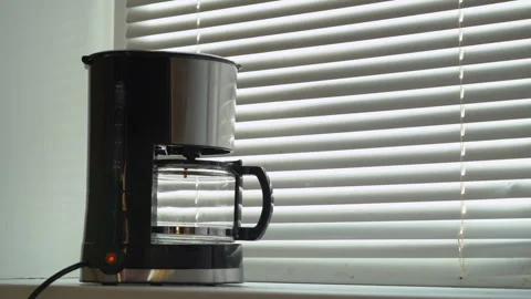 First drops of coffee fall into a transparent teapot. Coffee maker is making. Stock Footage 256285194